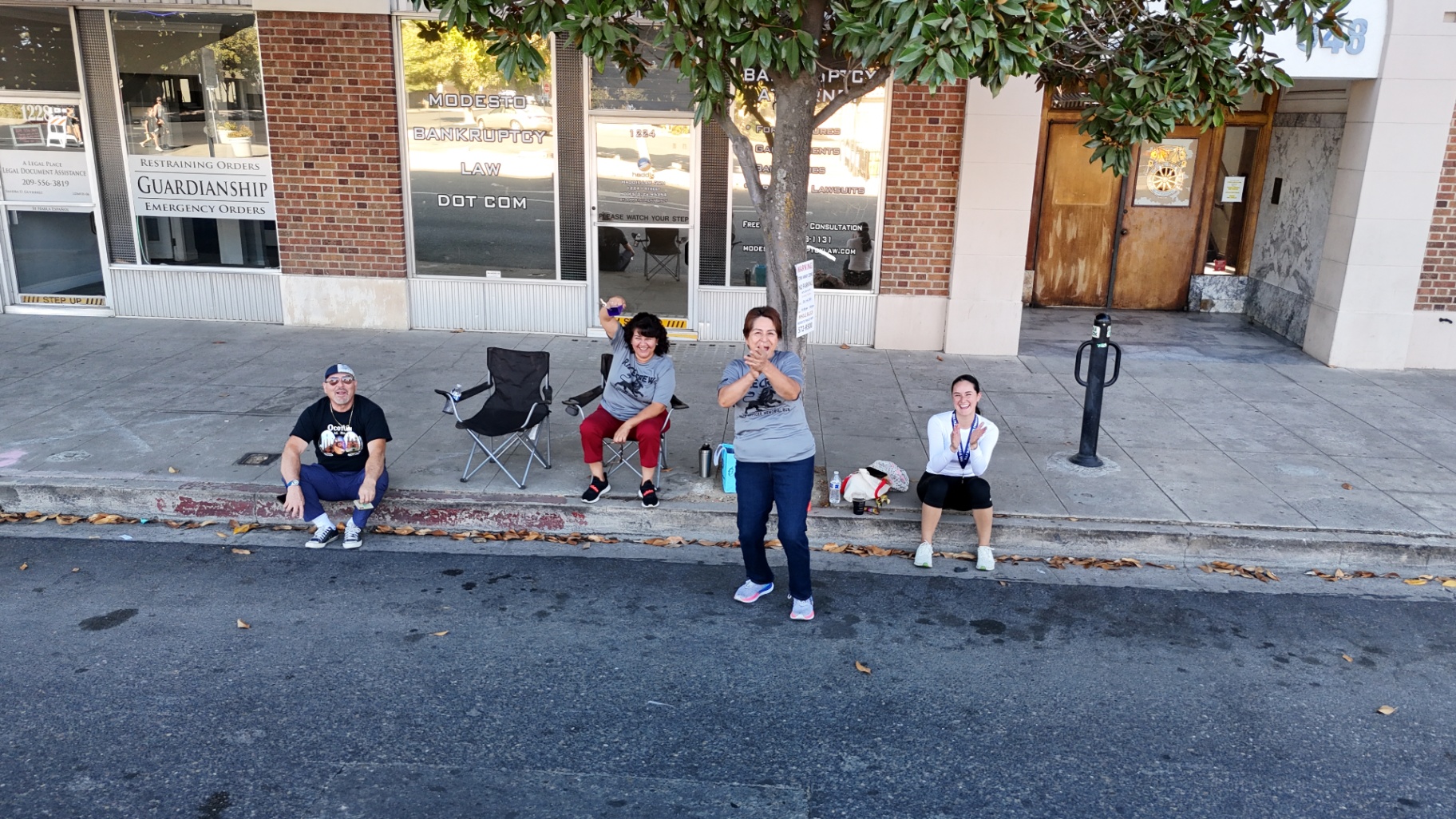 People waving from the curb