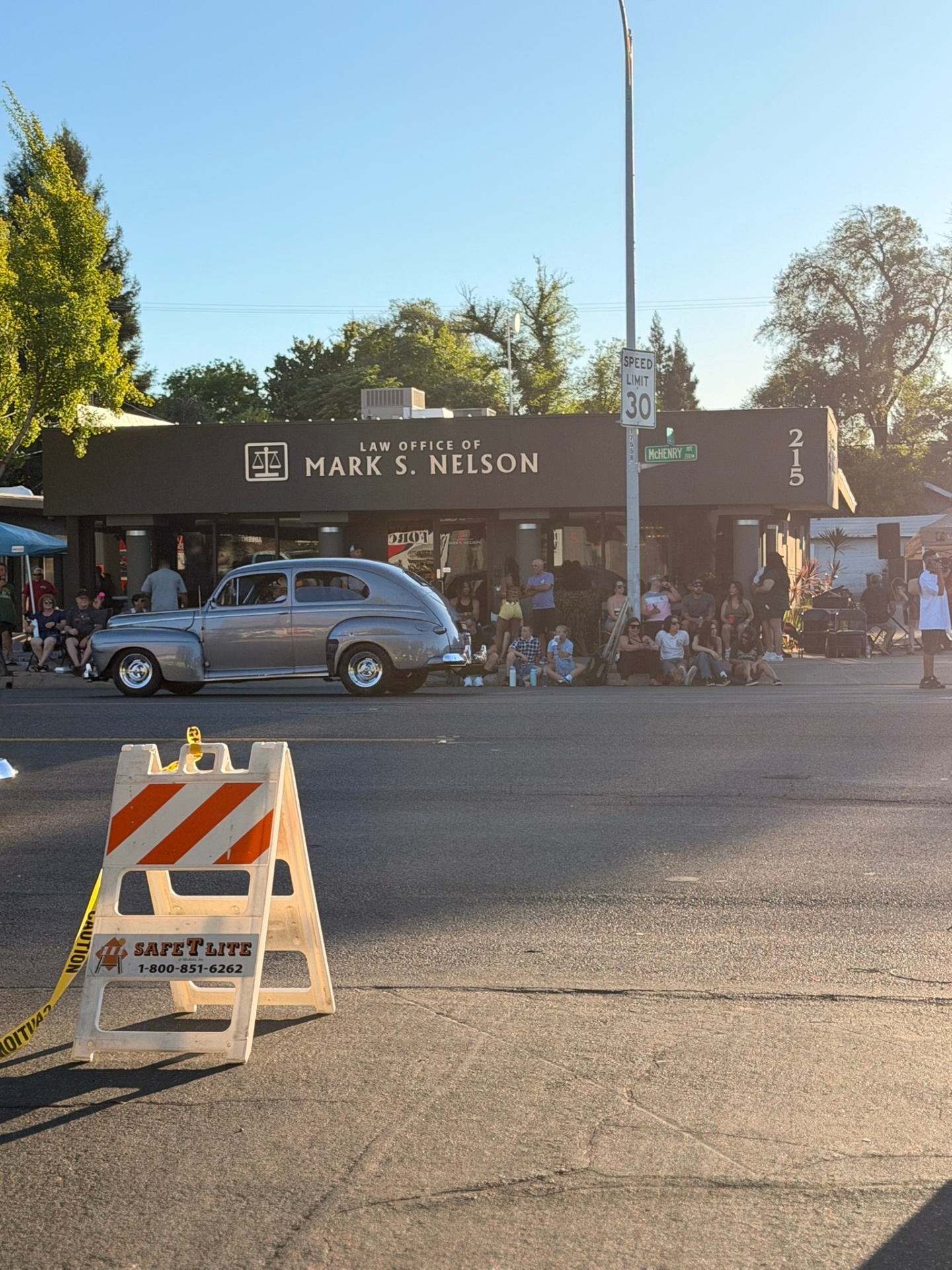 Classic car cruising past the crowd